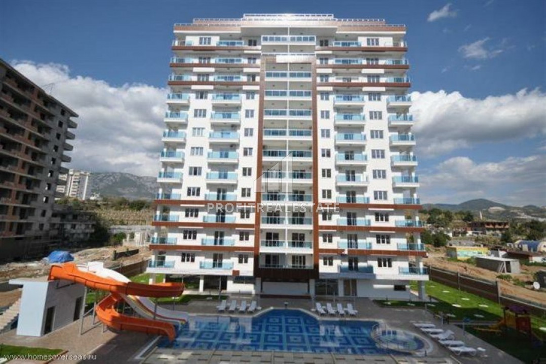 1 + 1 layout apartment in a residence with rich facilities near the sea in Mahmutlar ID-6474 фото-1