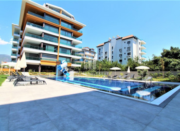 New 1 + 1 apartment in a luxury residence overlooking the Alanya fortress on the seashore in the Kestel area ID-8143 фото-1