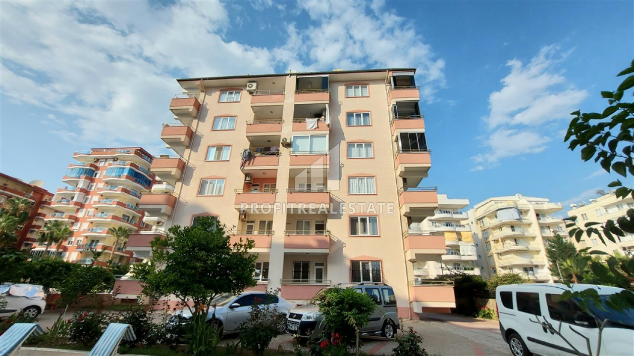 Three bedroom apartment with a separate kitchen on the first coastline in Mahmutlar ID-9249 фото-1