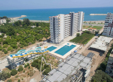Apartment 1 + 1, 2 + 1 on different floors in a residence with a water park in the district center of Erdemli ID-9295 фото-1