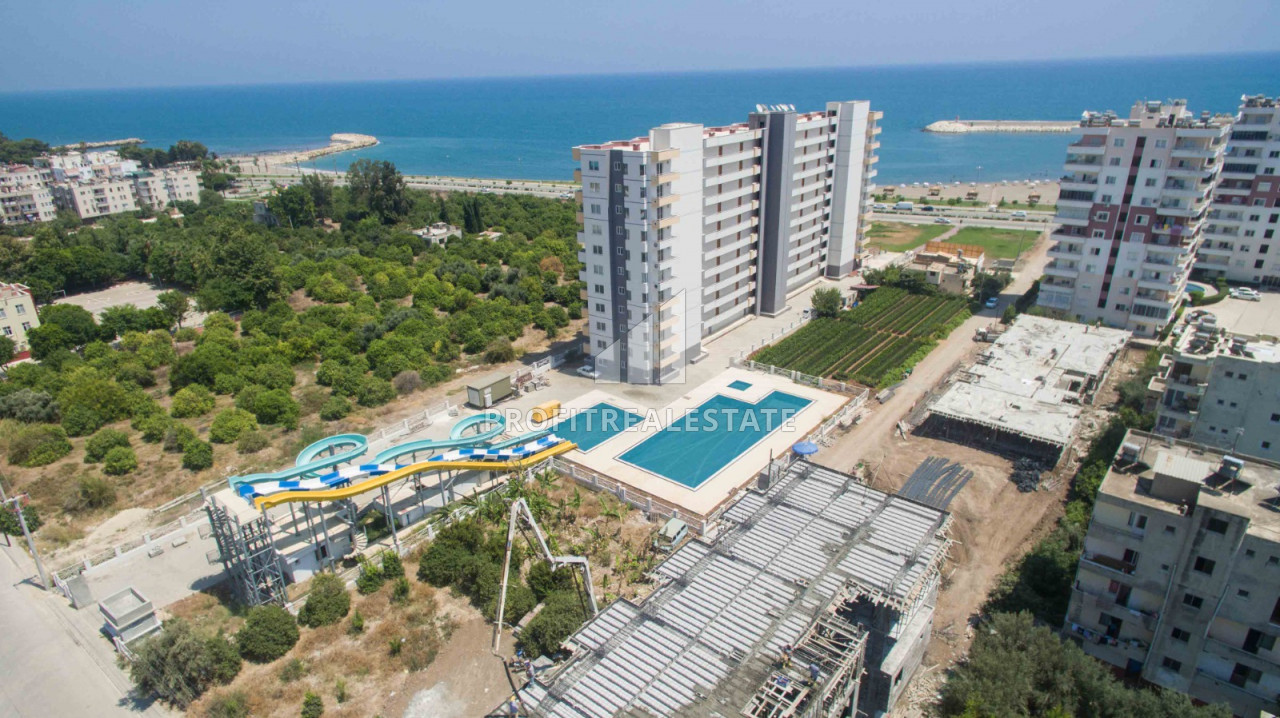 Apartment 1 + 1, 2 + 1 on different floors in a residence with a water park in the district center of Erdemli ID-9295 фото-1