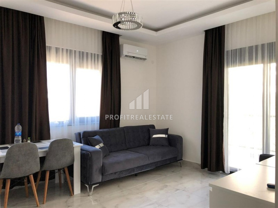 Furnished one-bedroom apartment in a new residence with good facilities in Mahmutlar ID-9350 фото-1