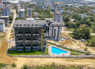 New apartment 1 + 1 with a private garden and swimming pool in a residence with good facilities in Avsallar ID-9359 фото-2