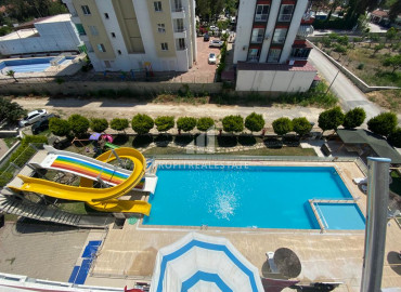 Меблированная  квартира 1+1 в комплексе с бассейном и собственным пляжем в районе Мерсина – Чешмели ID-9858 фото-1