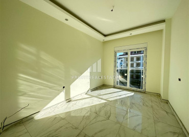 Двухкомнатная квартира 50 м2 в новостройке, с чистовой отделкой, сантехникой, без мебели, в 300 метрах от моря в Кестеле, Аланья ID-12537 фото-2