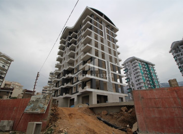Новая квартира с одной спальней, 50м². в комплексе на этапе строительства в районе Махмутлар, Алания ID-12632 фото-1