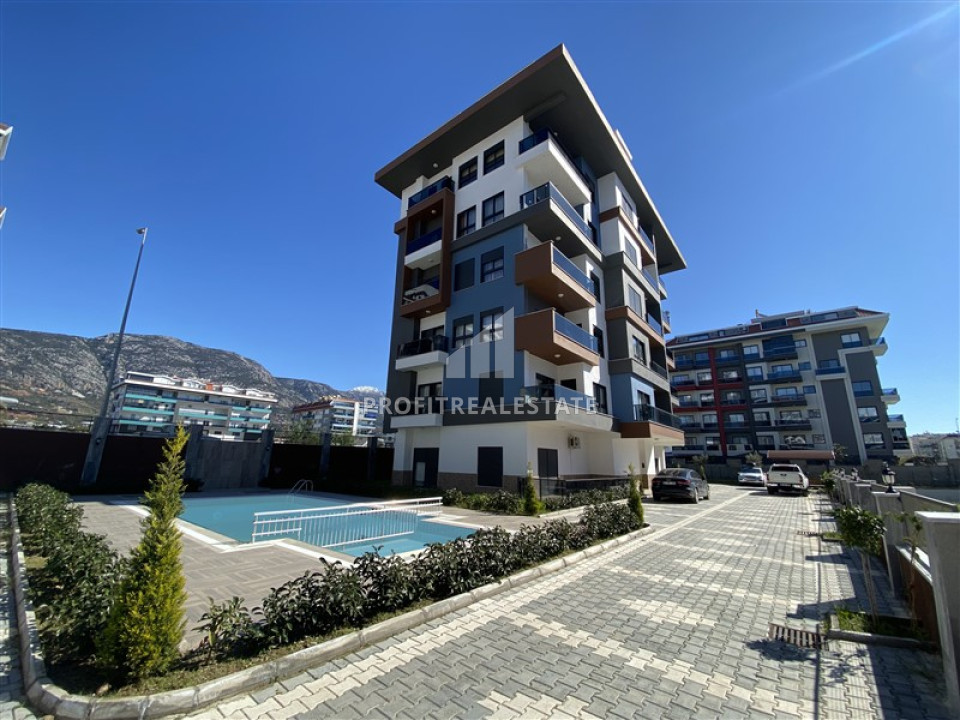Симпатичная меблированная двухкомнатная квартира, 56м², в новом комплексе в 200м от моря в районе Кестель ID-12835 фото-1