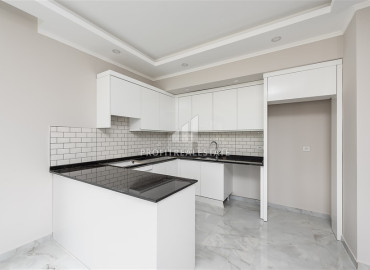 Новая двухкомнатная квартира 65 м2, без мебели, с кухонным гарнитуром, в новостройке с инфраструктурой в Авсалларе, Аланья ID-12866 фото-6