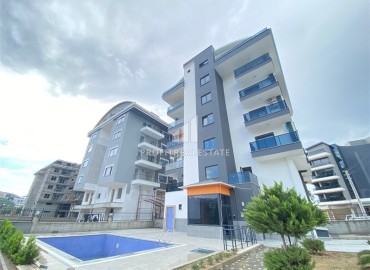Двухкомнатная квартира в новостройке 55 м2, с чистовой отделкой, без мебели, в 200 метрах от моря в Каргыджаке, Аланья ID-13078 фото-1