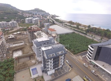 One-bedroom apartment in a new building 55 m2, with a fine finish, unfurnished, 200 meters from the sea in Kargicak, Alanya ID-13078 фото-2