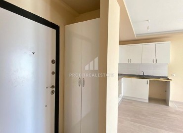 Двухкомнатные апартаменты, 55м², в доме городского типа в районе Томюк, Мерсин, по привлекательной цене ID-13727 фото-1