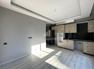 One-bedroom apartment, 55m², in a new urban-type building in Tomuk, Mersin ID-13845 фото-7
