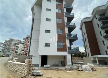 One bedroom apartment, 63m², in a residence under construction, 550m from the sea in Tosmur, Alanya ID-14187 фото-13