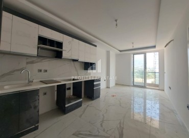 Inexpensive unfurnished one-bedroom apartment, 58m2, in a new residential residence with facilities, Mahmutlar, Alanya ID-14424 фото-3