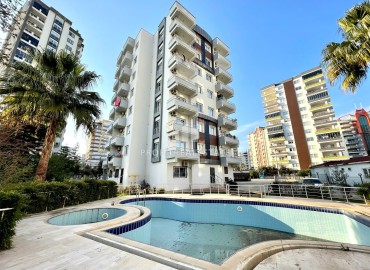 One-bedroom furnished apartment, 60m², in a residence with a swimming pool in the center of Yenişehir, Mersin ID-14560 фото-1
