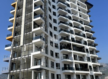 Excellent one-bedroom apartment, 59m², in a residence under construction with hotel facilities 450 meters from the sea in Mahmutlar ID-11544 фото-1