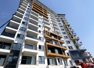 Excellent one-bedroom apartment, 59m², in a residence under construction with hotel facilities 450 meters from the sea in Mahmutlar ID-11544 фото-2