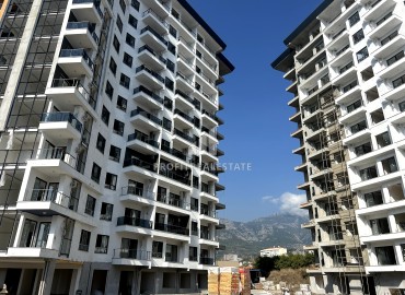 Excellent one-bedroom apartment, 59m², in a residence under construction with hotel facilities 450 meters from the sea in Mahmutlar ID-11544 фото-3