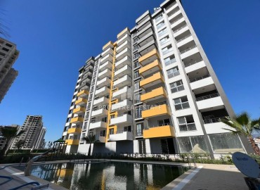 Двухкомнатные апартаменты, 60м², в новостройке с хорошей инфраструктурой в 550м от моря в Эрдемли, Арпачбахшиш ID-15376 фото-1