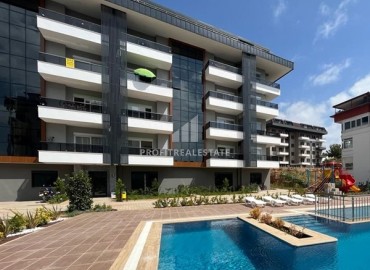 Unfurnished one bedroom apartment 55 m², with kitchen unit, in a new residential residence with facilities, Oba, Alanya ID-15546 фото-1