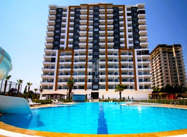 Новые апартаменты 2+1, 110м², с чистовой отделкой в районе Томюк, Эрдемли, в 500м от Средиземного моря ID-15638 фото-1