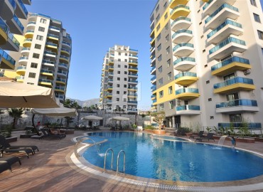 New one-bedroom apartment 55m², with sea and mountain views, in a residential residence with facilities, Mahmutlar, Alanya ID-15741 фото-1