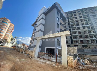 Новая квартира с двумя спальнями, 85м², в новостройке с бассейном, в 400м от моря в районе Тосмур, Алания ID-16076 фото-1