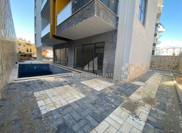 Новая квартира с двумя спальнями, 85м², в новостройке с бассейном, в 400м от моря в районе Тосмур, Алания ID-16076 фото-18