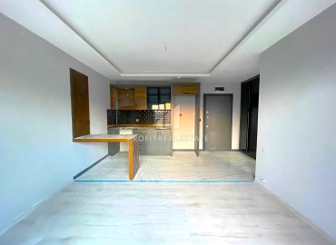 Квартира с одной спальней, 50м², в новом комплексе с бассейном в районе Томюк, Мерсин по супер цене ID-16334 фото-2