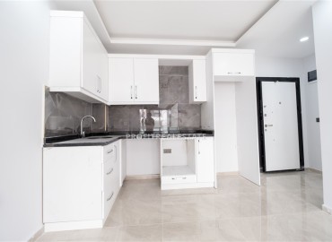 New one bedroom apartment, 45 m², in an urban house 50 m from the sea in Oba, Alanya, at a competitive price ID-15454 фото-3