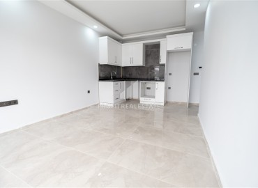 New one bedroom apartment, 45 m², in an urban house 50 m from the sea in Oba, Alanya, at a competitive price ID-15454 фото-5