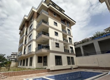 New 3+1 apartment with sea views, unfurnished, with a separate kitchen with built-in fittings, in the center of Alanya ID-16703 фото-1