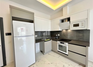 Меблированная квартира с одной спальней, 55м², в комфортабельной новостройке в Махмутларе, Алания ID-16787 фото-4