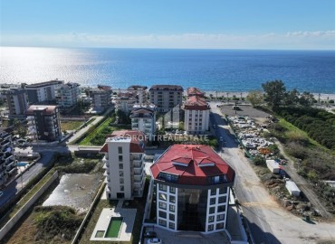 Апартаменты с одной спальней, 55м², в комфортабельной новостройке в 50м от моря, Кестель, Алания ID-18035 фото-1