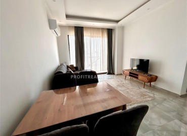 Двухкомнатные меблированные апартаменты, 56м², в комфортабельной новостройке в центре Махмутлара, Алания ID-18349 фото-4