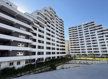 Апартаменты 1+1, 70м², в элитном комплексе на окончательном этапе строительства в районе Томюк, Эрдемли ID-18375 фото-2