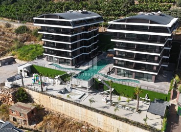 Profitable investment project 600 meters from Cleopatra beach in a residence with developed facilities in the center of Alanya ID-10993 фото-1