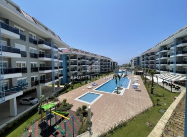 Стильные апартаменты 1+1, 55м², в элитном комплексе в 300 метрах от моря в районе Кестель, Алания ID-18398 фото-1