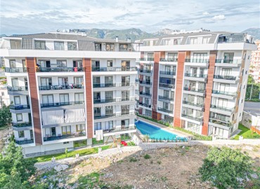 Новая квартира с одной спальней, 50м², в комфортабельном комплексе, в 550м от моря в районе Тосмур, Алания ID-18404 фото-1