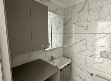 Новая квартира с одной спальней, 50м², в комфортабельном комплексе, в 550м от моря в районе Тосмур, Алания ID-18404 фото-8