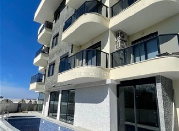 Новые апартаменты с одной спальней, 50м², в комплексе с бассейном в районе Махмутлар, Алания, по привлекательной цене ID-18507 фото-1