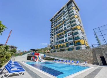 Двухкомнатная меблированная квартира, 50м², с видом на горы в комплексе с отельной инфраструктурой в Махмутларе, Алания ID-18512 фото-1