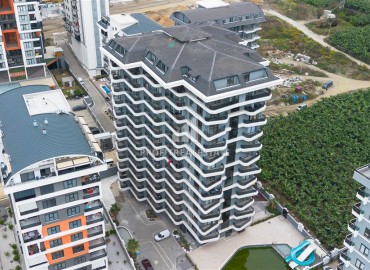 Апартаменты 1+1, 49м², в комплексе премиум класса на окончательном этапе строительства в центре Махмутлара, Алания ID-17346 фото-1