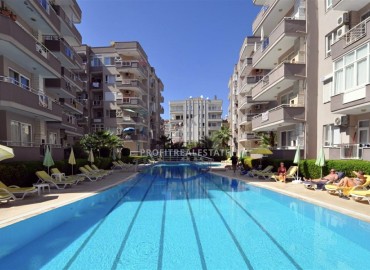 Недвижимость в 50м от моря: меблированная трехкомнатная квартира, 93м², в уютном комплексе в Махмутларе, Алания ID-18596 фото-1