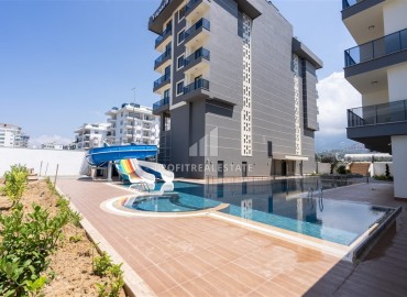 Апартаменты с одной спальней, 55м², в новостройке с отличной локацией в 300м от моря в районе Каргыджак, Алания ID-18689 фото-1