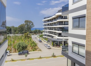 Новые двухкомнатные апартаменты, 55м², с дизайнерским интерьером, в 150м от моря в районе Каргыджак, Алания ID-18801 фото-11