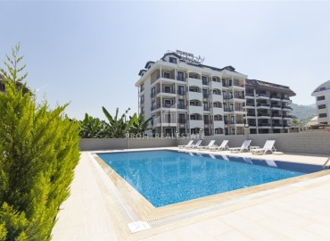 Новые двухкомнатные апартаменты, 55м², с дизайнерским интерьером, в 150м от моря в районе Каргыджак, Алания ID-18801 фото-14