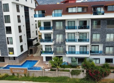 Уютная квартира с одной спальней, 55м² в современной резиденции с хорошей инфраструктурой в Махмутларе, Алания ID-18920 фото-1