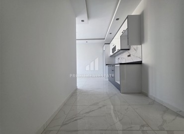 Апартаменты с одной спальней, 55м², в новостройке с хорошей инфраструктурой в 600м от моря в Махмутларе, Алания ID-18955 фото-4