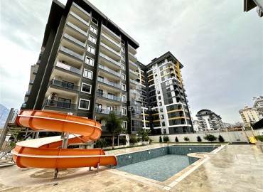 Уютная квартира с одной спальней, 55м², с видом на горы в комплексе премиум класса, в центральной части Махмутлара, Алания ID-18956 фото-1